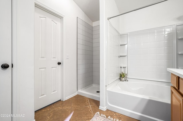 bathroom featuring tile patterned flooring, vanity, and tiled shower