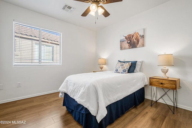 bedroom with ceiling fan and hardwood / wood-style floors