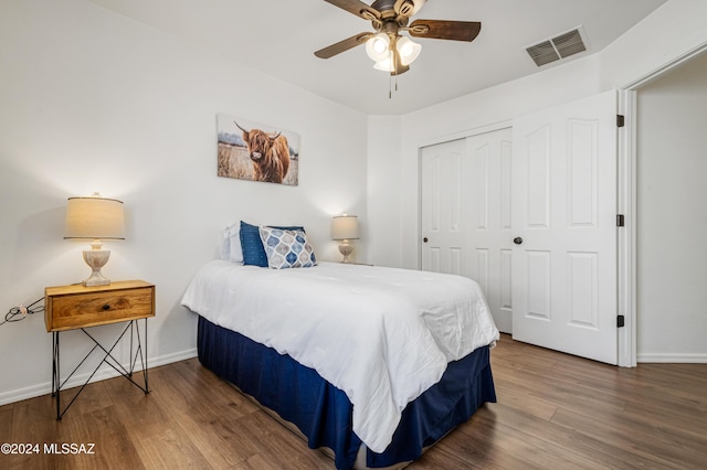 bedroom with wood-type flooring, a closet, and ceiling fan