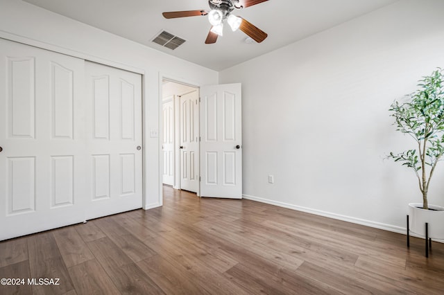 unfurnished bedroom with ceiling fan, a closet, and light hardwood / wood-style floors