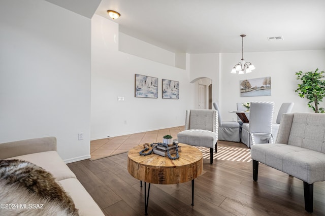 living room with a notable chandelier and wood-type flooring