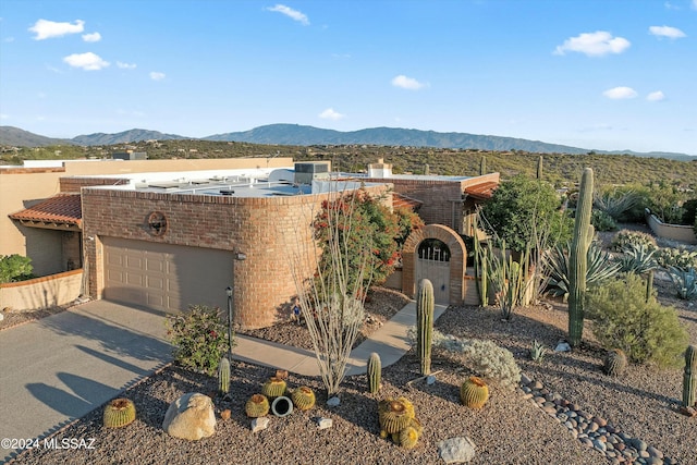 view of front of house with a mountain view and a garage