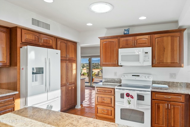 kitchen with white appliances and light tile patterned floors