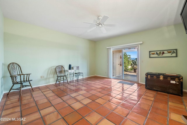 living area with tile patterned flooring and ceiling fan