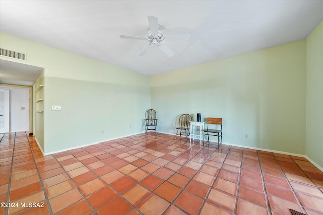 empty room featuring tile patterned floors and ceiling fan