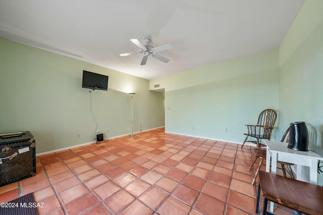 tiled spare room featuring ceiling fan