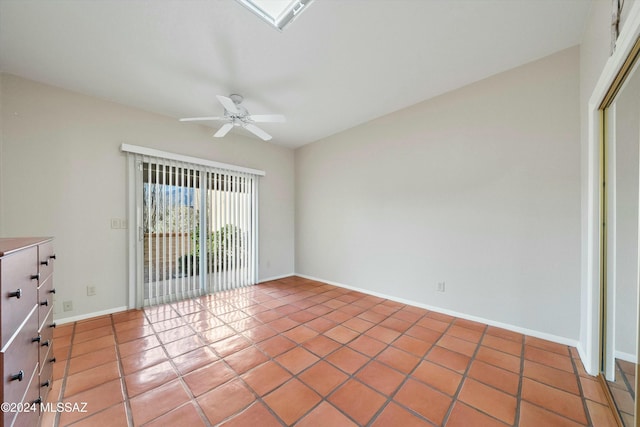 empty room featuring ceiling fan and tile patterned flooring