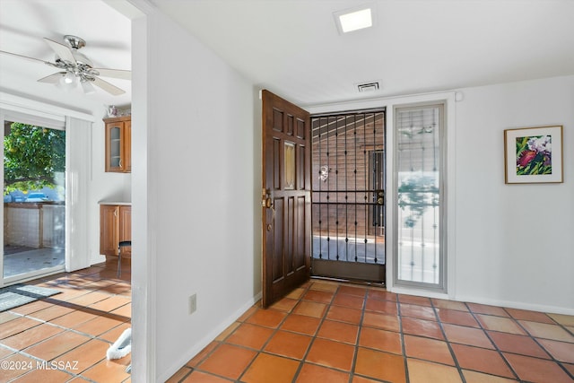 entryway with tile patterned floors and ceiling fan