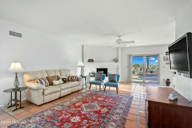 living room with ceiling fan and light tile patterned floors