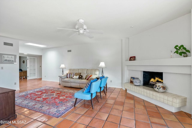 living room with tile patterned floors and ceiling fan