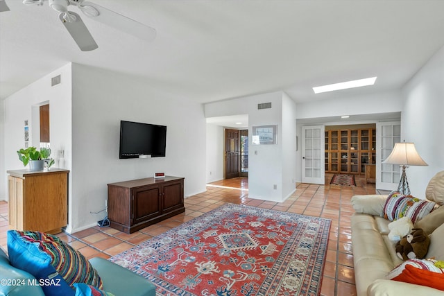 living room with ceiling fan, light tile patterned floors, and french doors