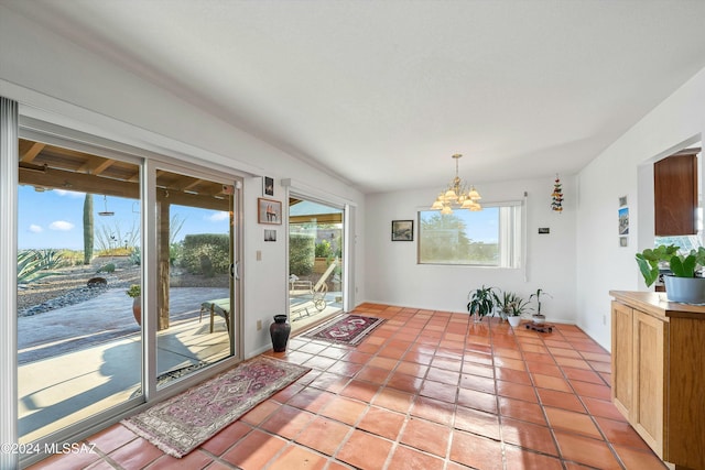 doorway to outside featuring tile patterned floors and an inviting chandelier