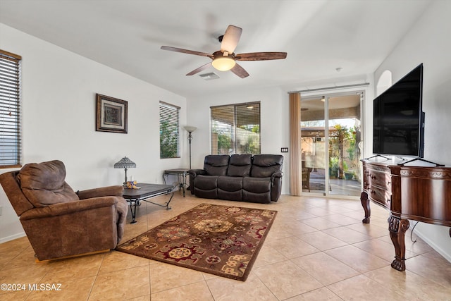 tiled living room with ceiling fan