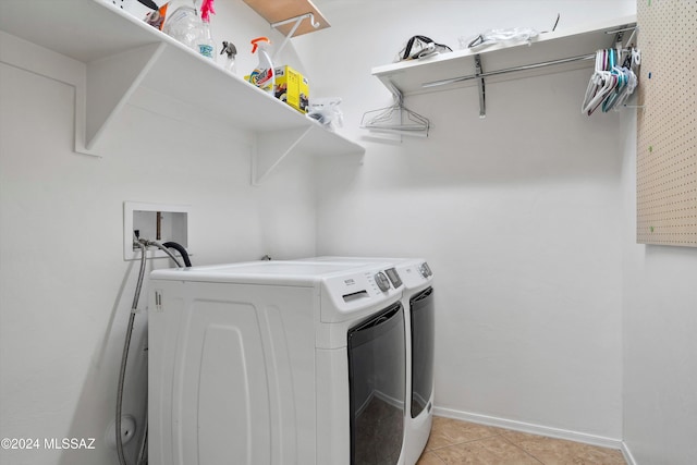 laundry room featuring light tile patterned flooring and independent washer and dryer