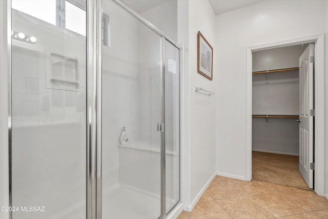 bathroom featuring tile patterned flooring and an enclosed shower