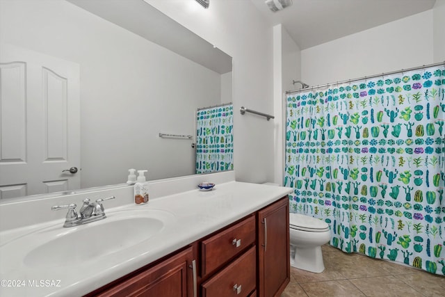 bathroom with toilet, vanity, tile patterned floors, and a shower with shower curtain