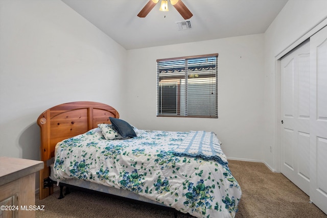 bedroom with ceiling fan, a closet, and carpet floors