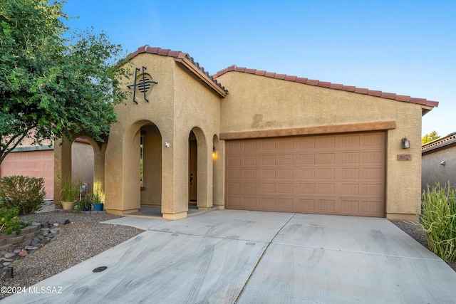 mediterranean / spanish home featuring a garage