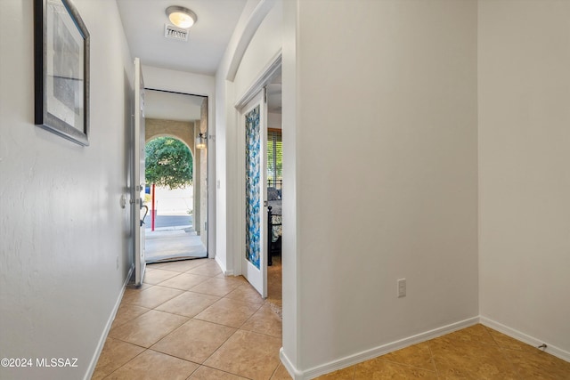 doorway to outside featuring light tile patterned floors