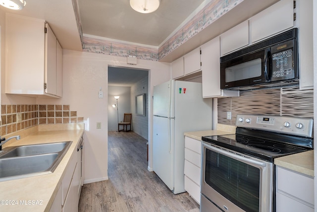 kitchen with sink, light hardwood / wood-style flooring, white fridge, white cabinetry, and stainless steel electric range