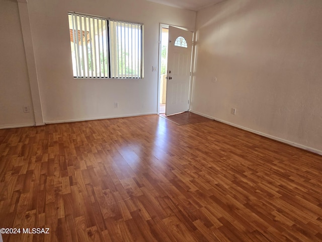 entryway with dark hardwood / wood-style flooring