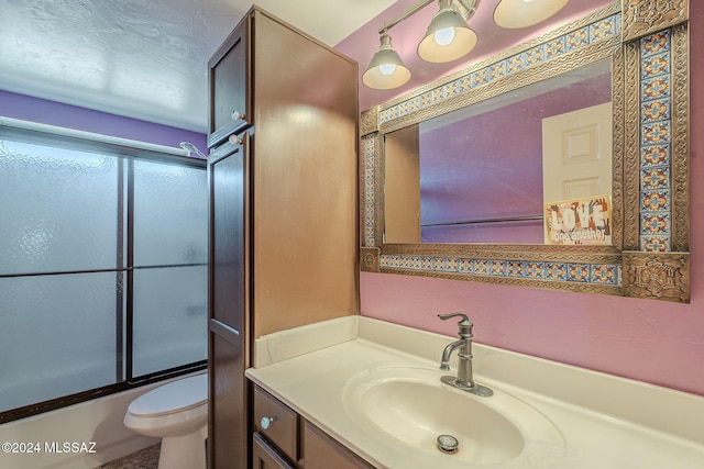 full bathroom with vanity, enclosed tub / shower combo, and toilet