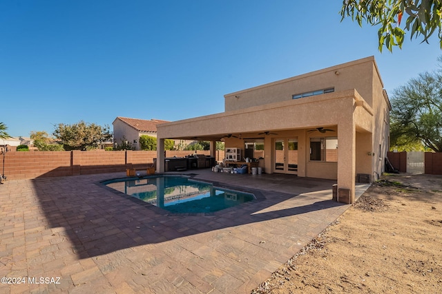 view of pool featuring ceiling fan, a patio area, and a jacuzzi