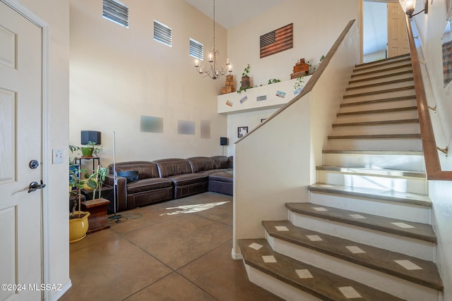 stairway featuring a notable chandelier