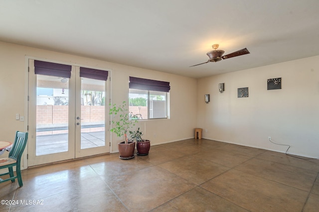 unfurnished room with ceiling fan and french doors