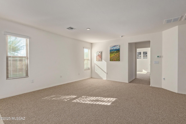 unfurnished room with light carpet