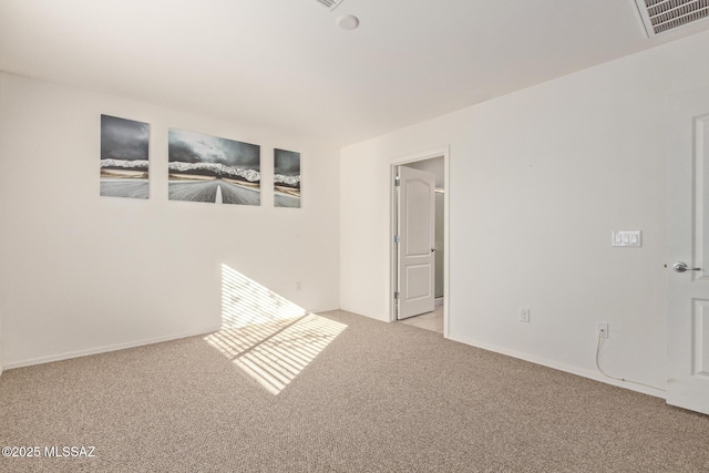 unfurnished room featuring light colored carpet