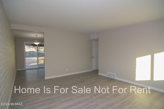 spare room with hardwood / wood-style floors