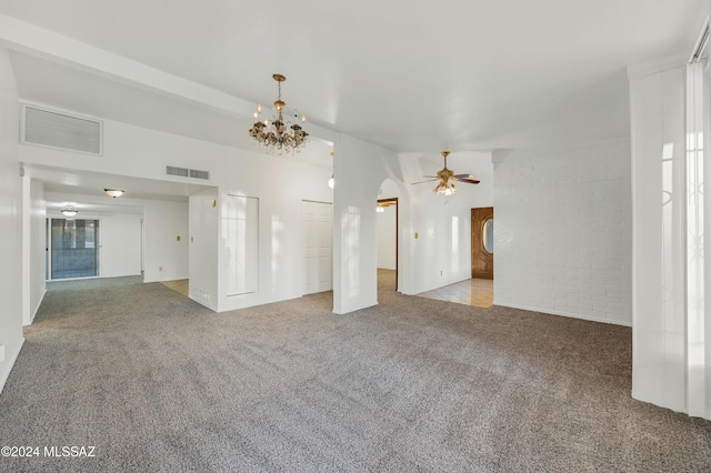 unfurnished living room with light carpet, brick wall, and ceiling fan with notable chandelier