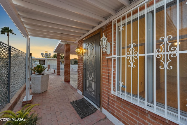 exterior entry at dusk with covered porch