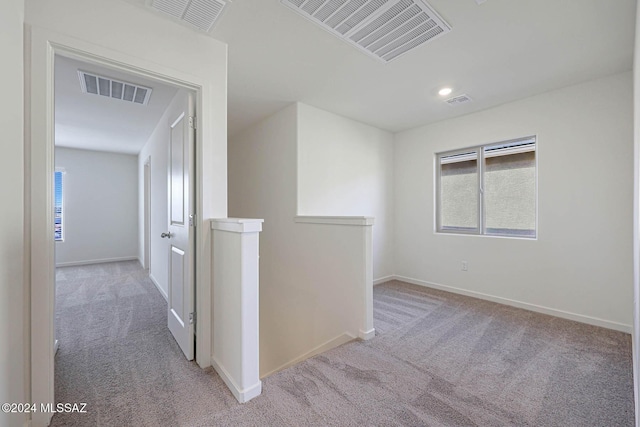 corridor with light colored carpet