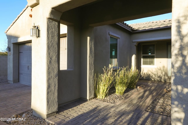 view of exterior entry featuring a garage