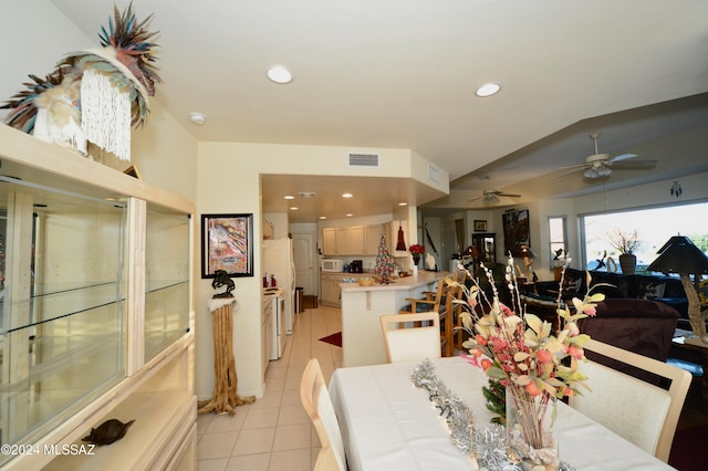 tiled dining space featuring ceiling fan