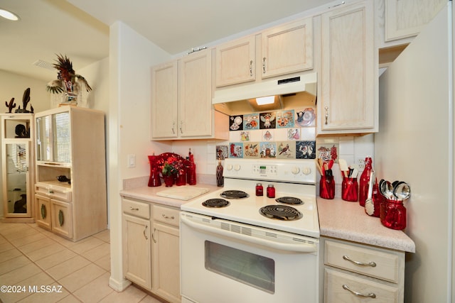 kitchen featuring white range with electric cooktop, light tile patterned floors, light brown cabinetry, and tasteful backsplash