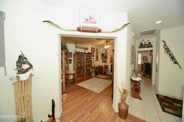 hallway with light hardwood / wood-style floors