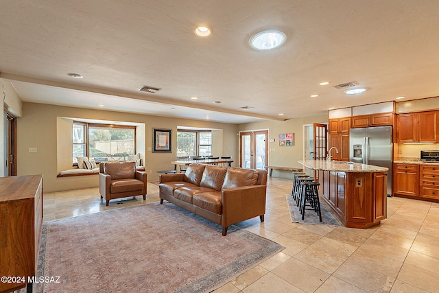 tiled living room featuring sink