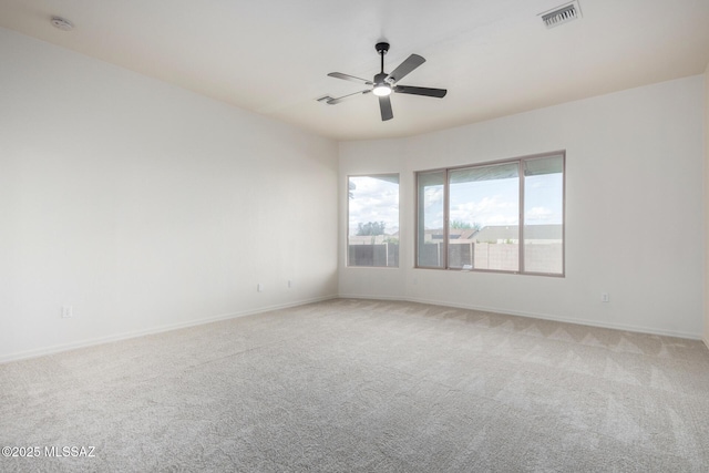 carpeted spare room with ceiling fan