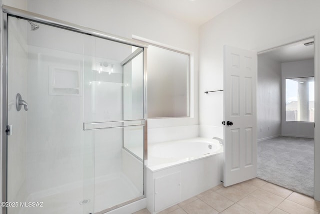 bathroom featuring tile patterned floors and independent shower and bath