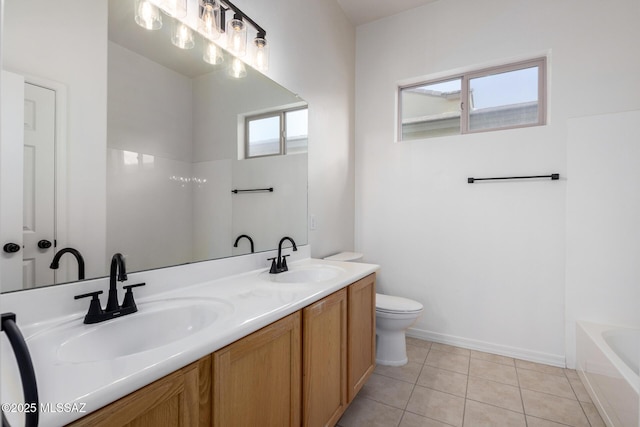 bathroom featuring tile patterned flooring, vanity, a bathtub, and toilet