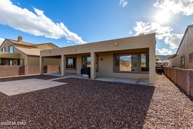 back of house featuring cooling unit and a patio