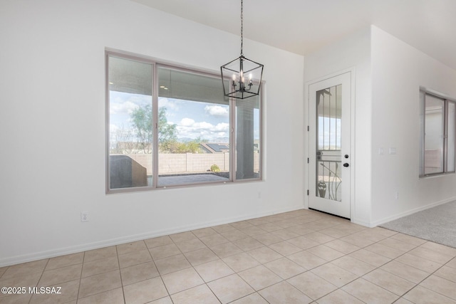 unfurnished dining area with an inviting chandelier and a wealth of natural light