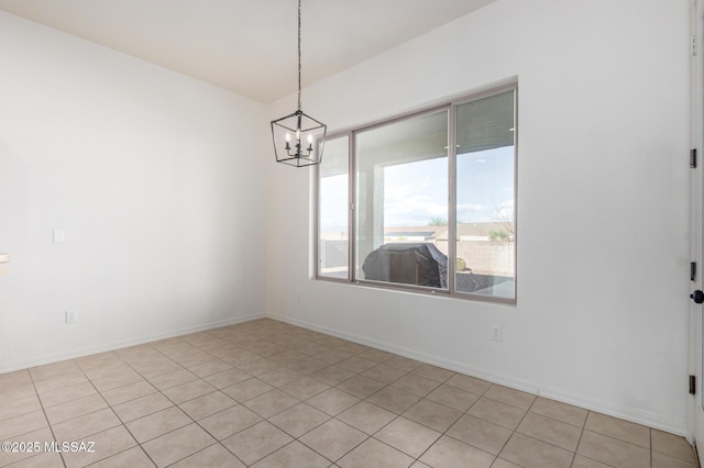 unfurnished room featuring an inviting chandelier