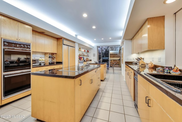 kitchen featuring light brown cabinets, light tile patterned floors, black appliances, and a kitchen island