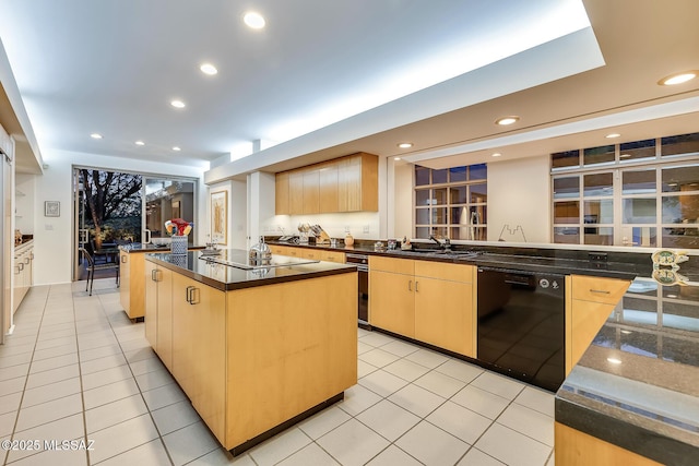 kitchen with light brown cabinets, light tile patterned flooring, a kitchen island, black appliances, and sink