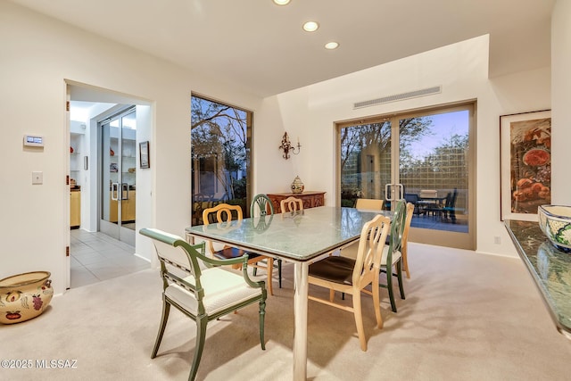 dining area featuring light colored carpet