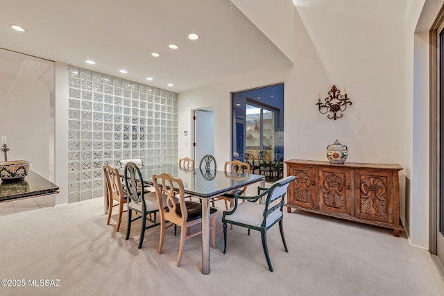 dining space with light colored carpet